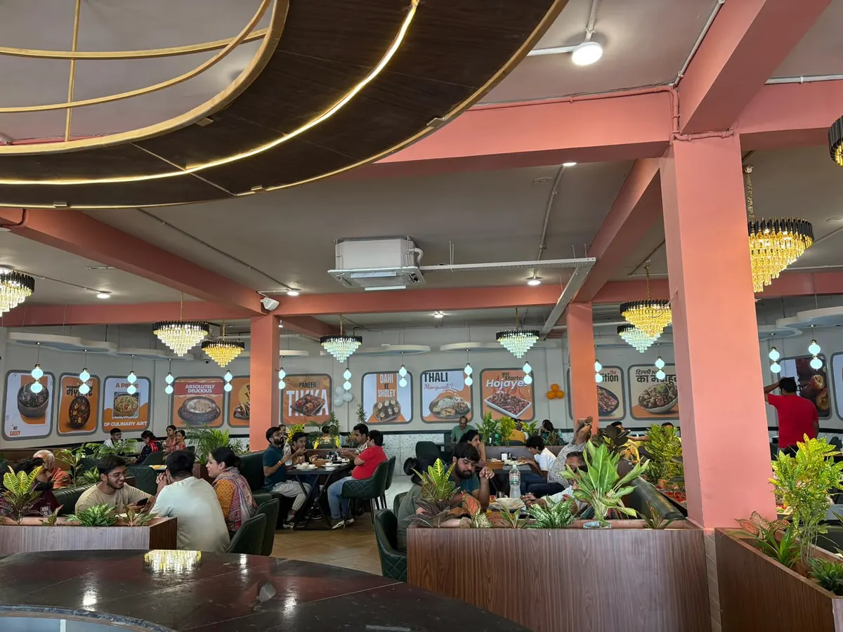 Family dining hall with booth seating and chandeliers inside Khadak Singh Da Dhaba